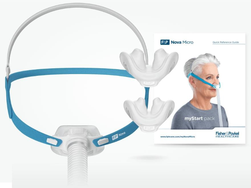 The Nova Micro mask shown beside two spare pillows cushions and Fisher & Paykel's quick reference guide