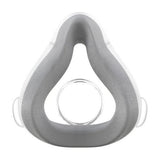 Front view of the ResMed AirTouch F20 cushion, grey UltraSoft memory foam on a clear shell, on white
