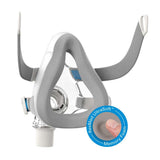 AirTouch F20 foam cushion fitted to its frame with headgear straps, beside a ResMed UltraSoft memory foam badge