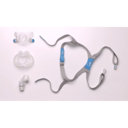 Flat lay of the AirFit F30 parts: cushion, frame, QuietAir elbow and the one-size headgear