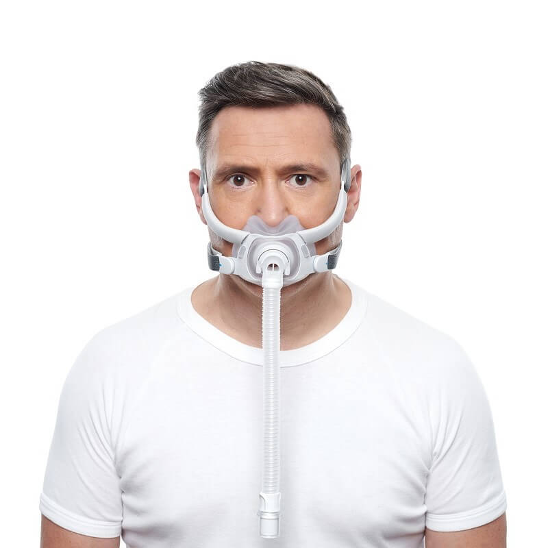 Photo of a man wearing the AirFit F40 from the front, the cushion under his nose and over his mouth