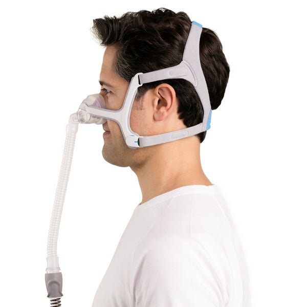 Side photo of a man wearing the AirFit N20, the cushion over his nose and the tube running down