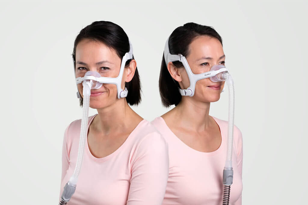 Two views of a woman wearing the AirFit N20 For Her, one from the front and one from the side