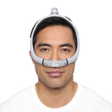 Photo of a man wearing the AirFit N30i from the front, the cradle cushion sitting under his nose