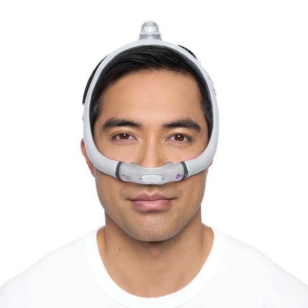 Photo of a man wearing the AirFit N30i from the front, the cradle cushion sitting under his nose