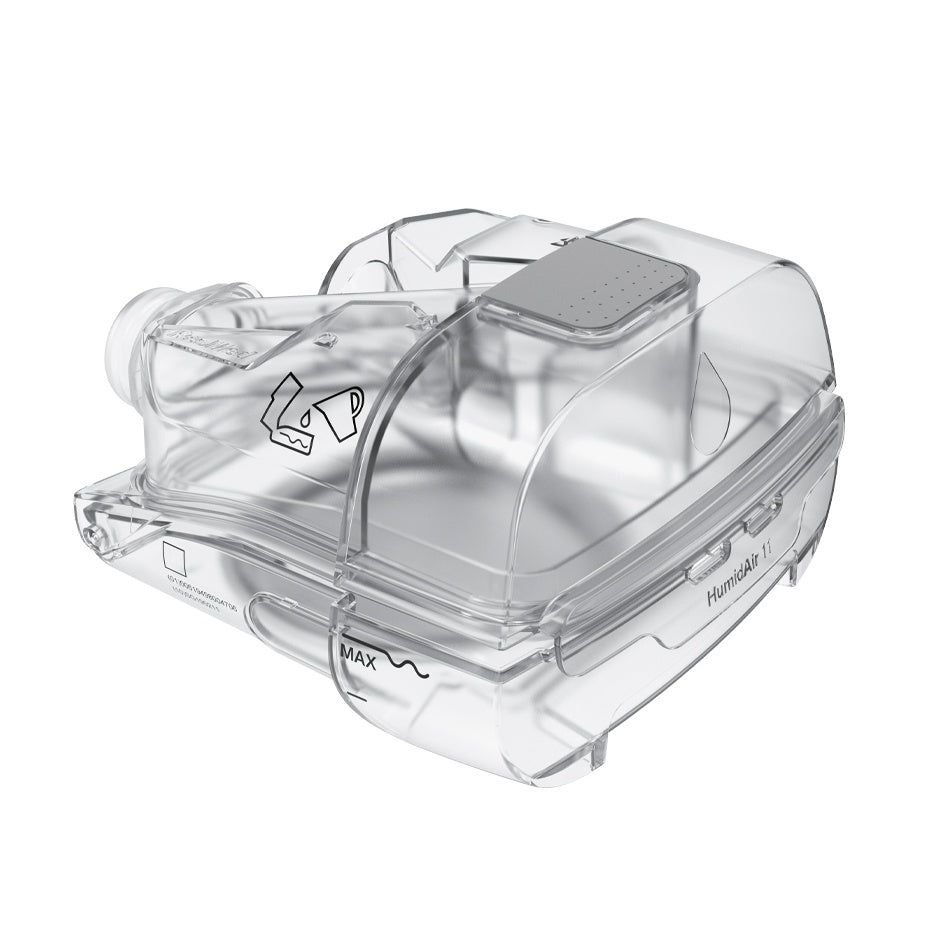 Angled view of the clear HumidAir 11 cleanable tub for AirSense 11, showing the grey grip and the max mark