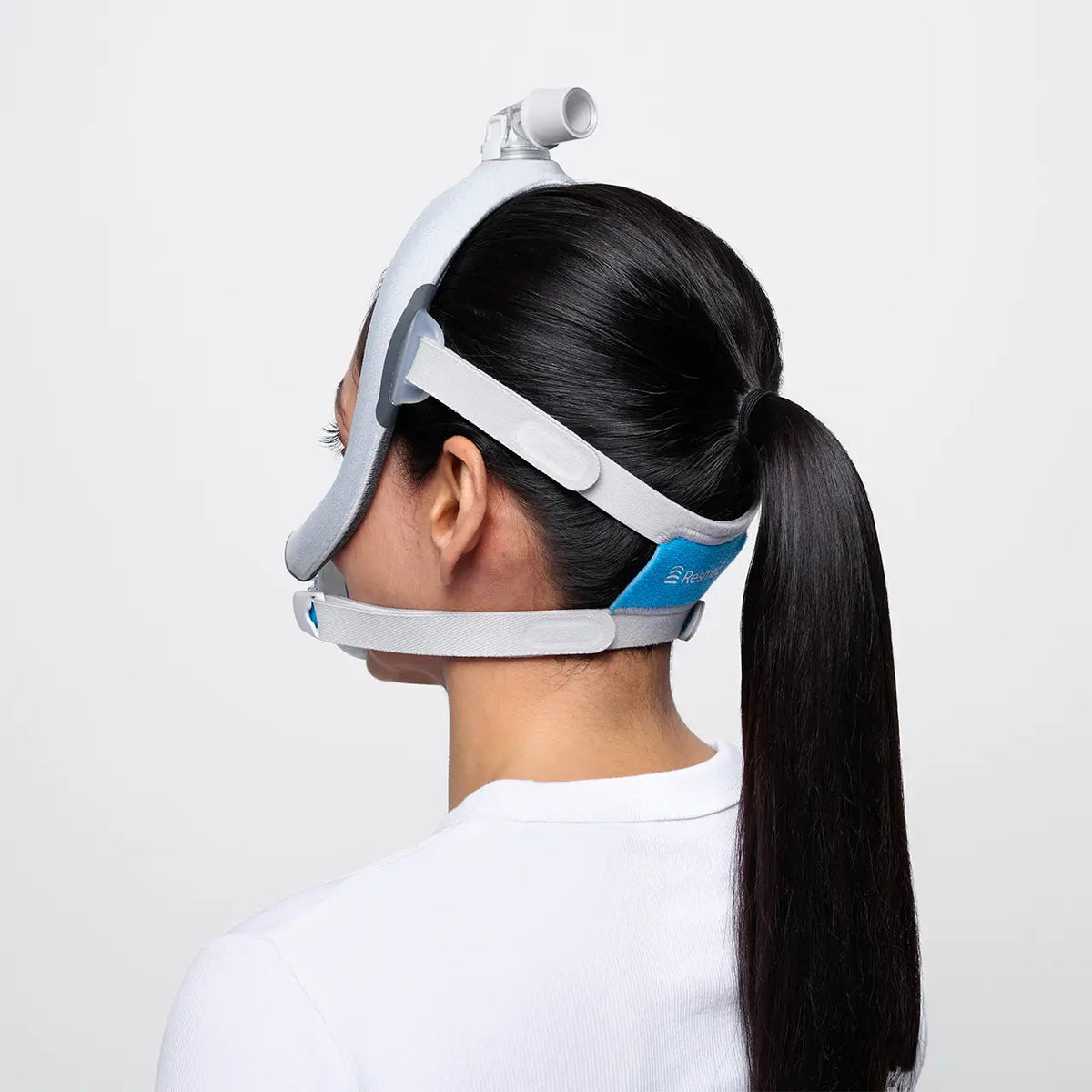 Rear view of a woman in the AirTouch F30i, its frame running up over her head to the elbow