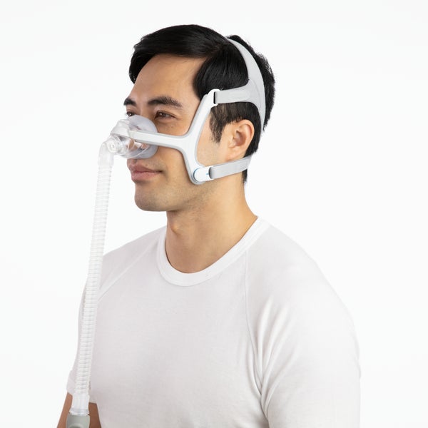 Side photo of a man wearing the AirTouch N20, with the tube falling straight down from the elbow