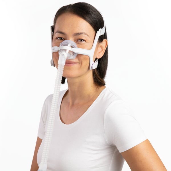 Photo of a woman wearing the AirTouch N20 For Her from the front, the tube running down