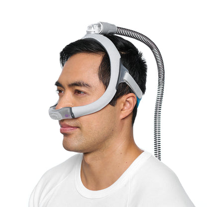 Side photo of a man wearing the AirTouch N30i, his hose connected at the top of his head