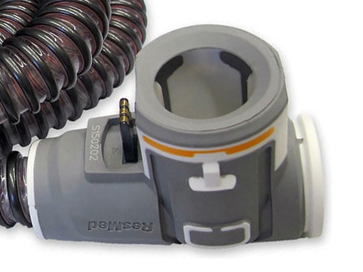 Close-up of the ClimateLineAir machine-end cuff for AirSense 10, showing the orange band and the electrical contact pin