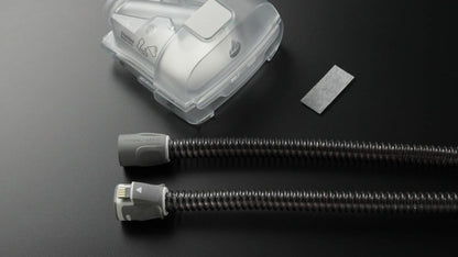 Both ends of the ClimateLineAir 11 laid side by side on a dark surface, next to a HumidAir 11 tub