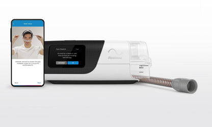 ResMed AirSense 11 with the ClimateLineAir 11 heated tube plugged in, beside a phone showing the mask setup screen