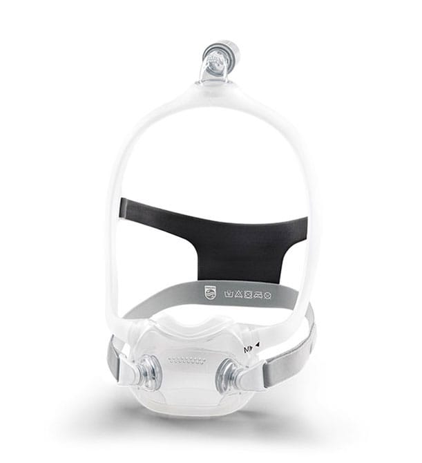 The DreamWear Full Face mask turned slightly, showing grey fabric headgear, the clear frame and the cushion's side ports