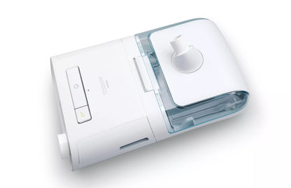 Top view of a Philips DreamStation with its heated humidifier attached, the clear water chamber seated under the lid