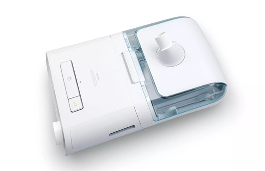 Top view of a Philips DreamStation with its heated humidifier attached, the clear water chamber seated under the lid