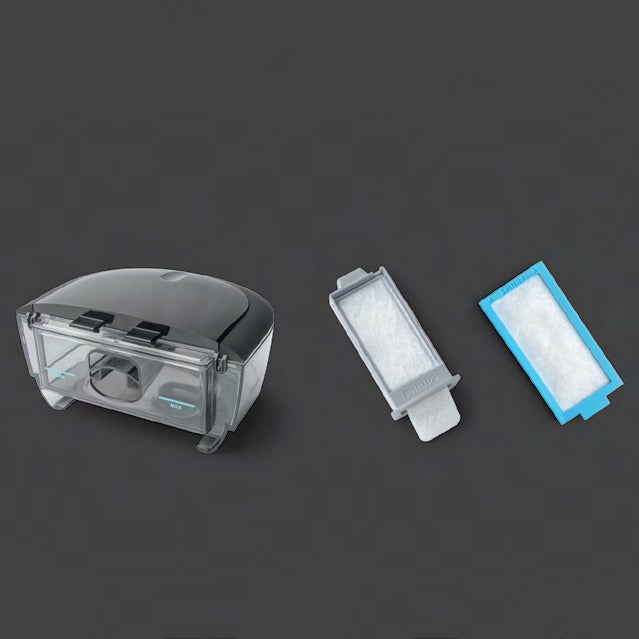 Photo of the DreamStation 2 water tank beside its grey reusable pollen filter and the blue disposable ultra-fine filter