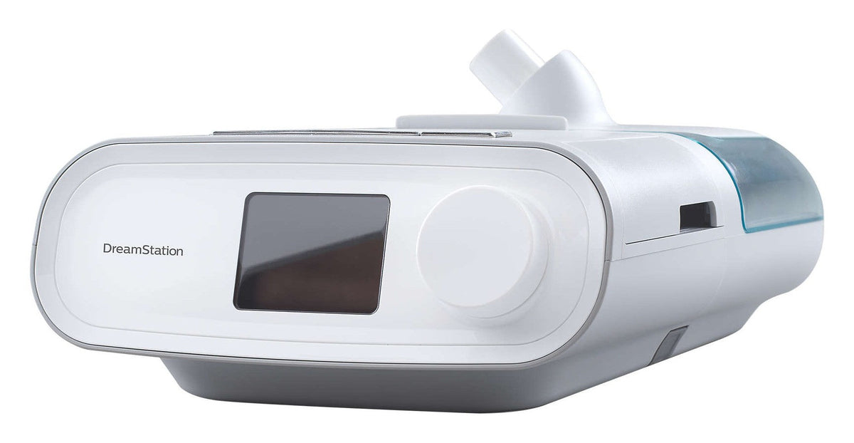 Three-quarter studio view of the DreamStation BiPAP Auto, with the clip-on humidifier at the back