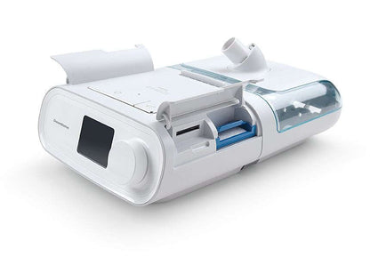 DreamStation BiPAP Auto with the side door open, showing the SD card slot and filter area