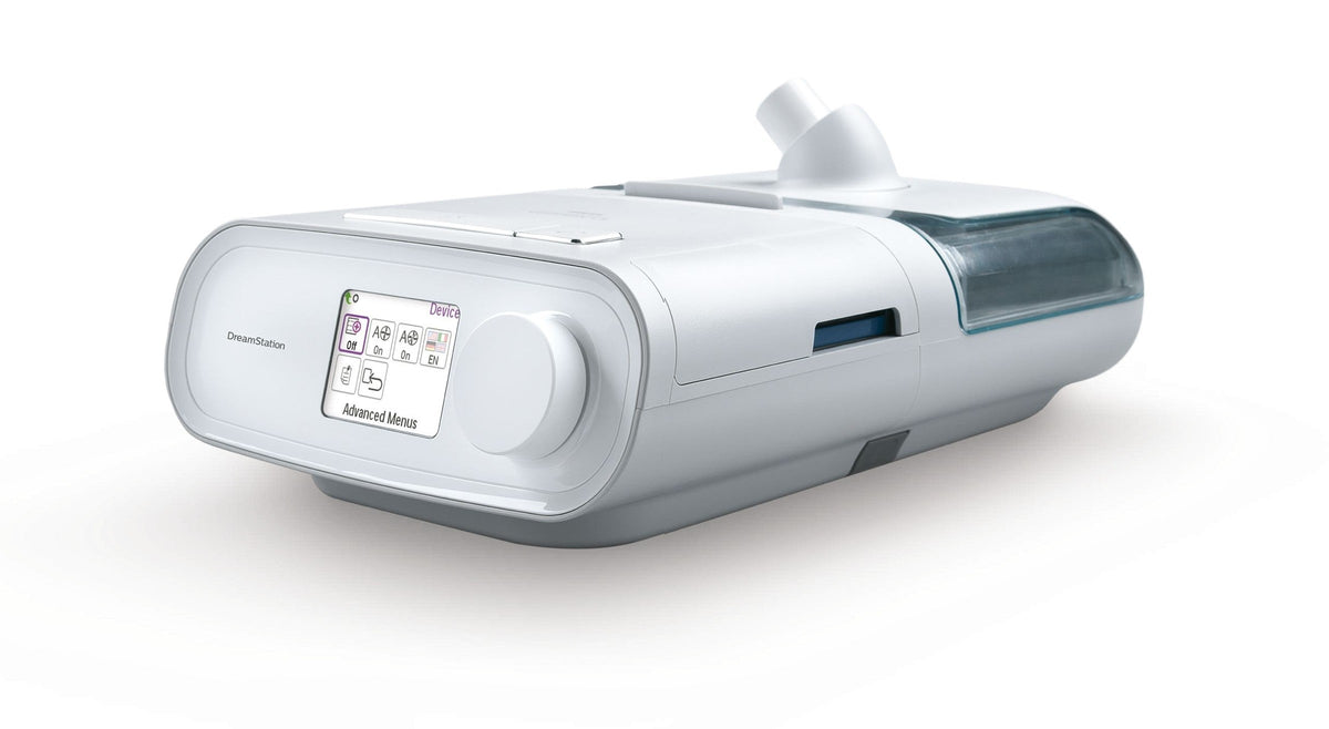 Angled view of the DreamStation Expert showing the dial, the Ramp button on top and the clip-on humidifier