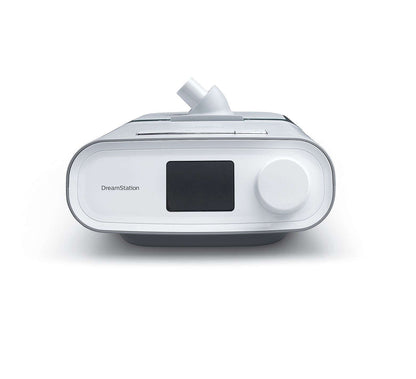 Front view of the Philips DreamStation Expert with its humidifier attached, showing the colour screen and control dial