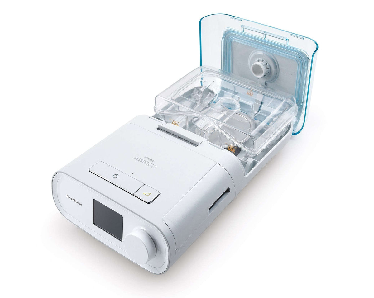 DreamStation Expert with the humidifier lid lifted, showing the clear water tank inside the clip-on humidifier