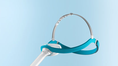 Angled view of the Evora Nasal on a blue background, showing the cap-style headgear from the side