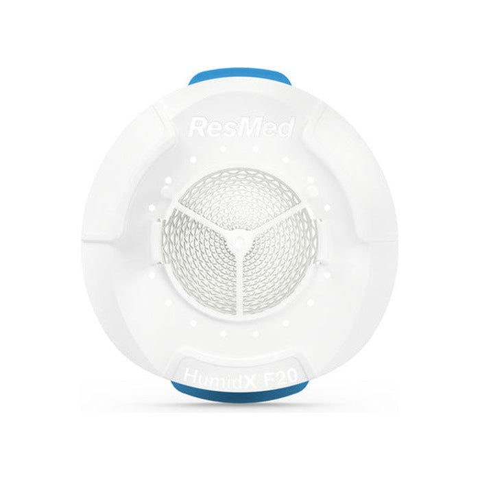 Front view of the round HumidX F20 waterless humidifier with its blue tabs at the top and bottom