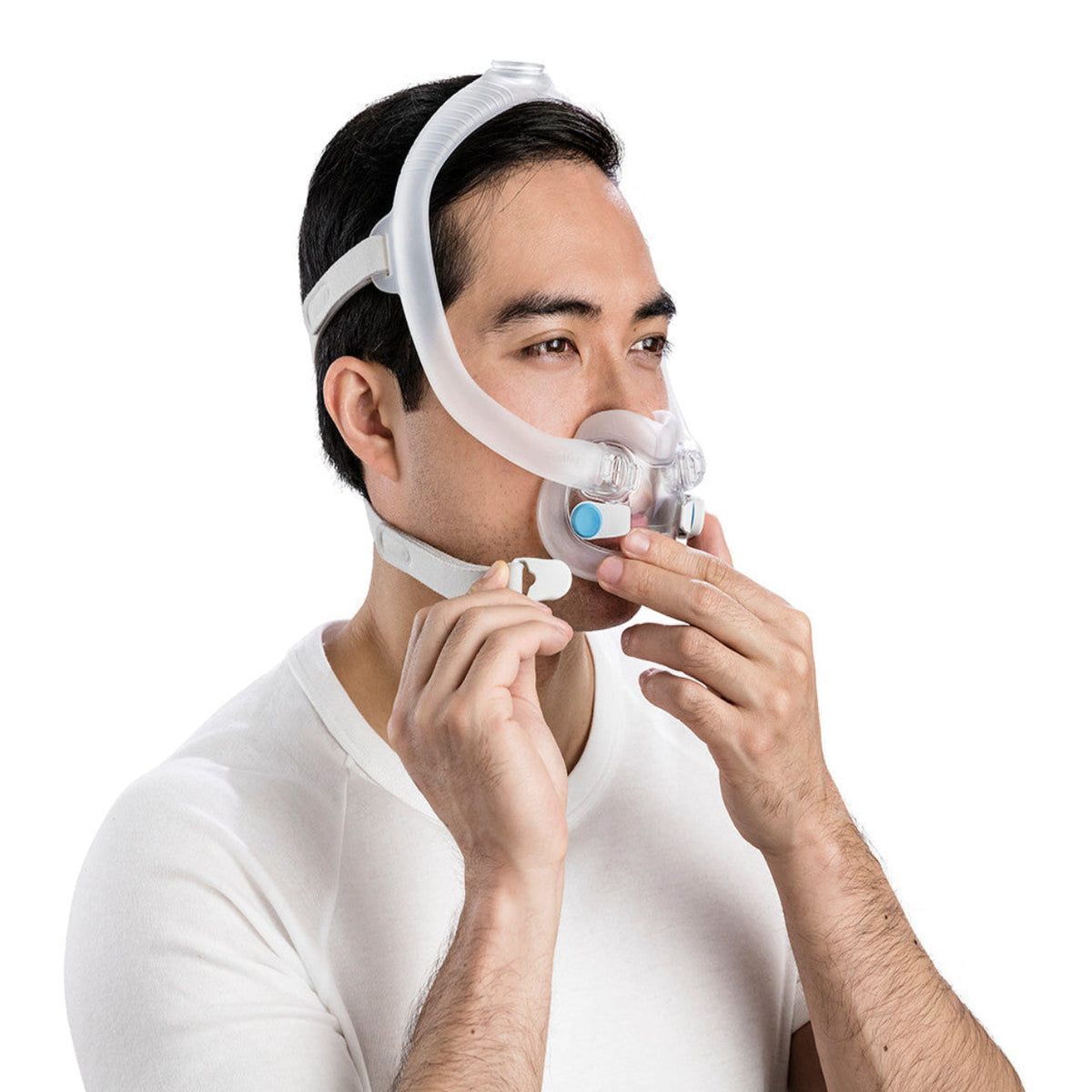 Man fitting an AirFit F30i, pressing a magnetic headgear clip onto the frame beside his mouth