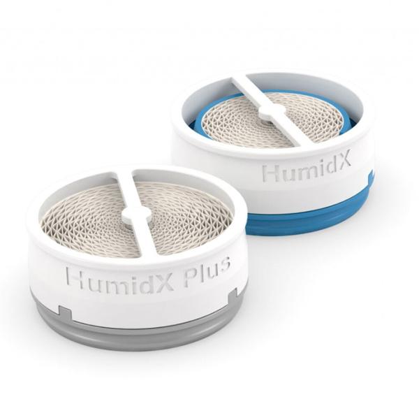 Angled view of a blue-based HumidX beside a grey HumidX Plus, showing the paper core inside each disc