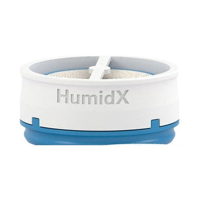 Front view of the ResMed HumidX waterless humidifier for AirMini, a white disc with a blue base
