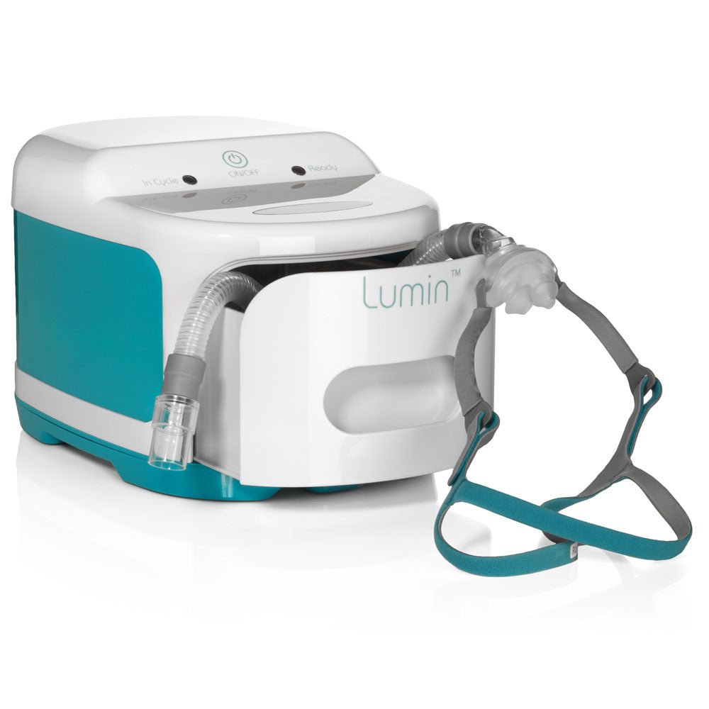Angled view of the Lumin sanitizer with a nasal pillow CPAP mask and its tubing resting in the open drawer