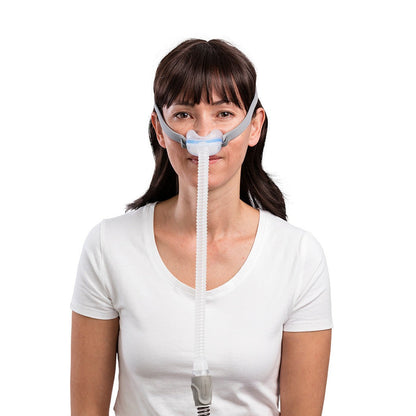 Woman wearing the AirFit N30 from the front, the grey bands running from the cushion back over her ears