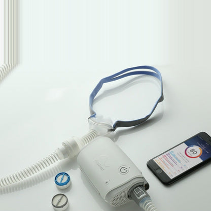 Overhead photo of the AirFit P10 for AirMini on an AirMini, beside a HumidX, a HumidX Plus and the app