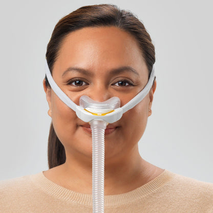 Photo of a woman wearing the Solo Pillows, facing forward, the cushion sitting at the base of her nose